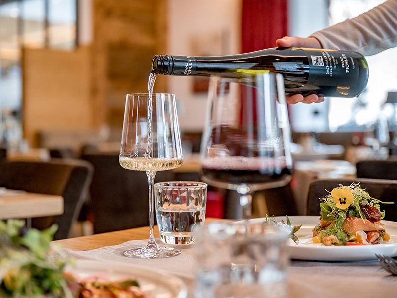 Waiter pouring wine