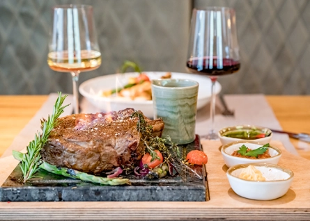 laid table with steak and wine