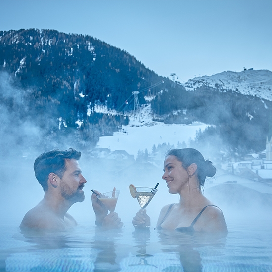 Couple with a drink in the pool